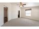 Bright bedroom with a ceiling fan, light gray carpet, and window with shade at 31555 N Royce Rd, San Tan Valley, AZ 85144