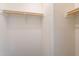 This walk-in closet has white walls and a long hanging rod at 31555 N Royce Rd, San Tan Valley, AZ 85144