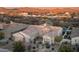 Aerial view of the home in a desert setting featuring a circular entryway, three-car garage, and mature landscaping at 31709 N 16Th Ave, Phoenix, AZ 85085