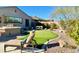 Lounge chair view of putting green, backyard bar, grill and landscaping at 31709 N 16Th Ave, Phoenix, AZ 85085