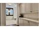 Bright bathroom featuring an arched doorway, a soaking tub, and white cabinetry at 31709 N 16Th Ave, Phoenix, AZ 85085