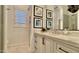 Bathroom featuring white cabinets and drawers and custom framed mirror at 31709 N 16Th Ave, Phoenix, AZ 85085