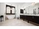 A luxurious bathroom features a soaking tub under arched windows and a vanity with a double sink at 31709 N 16Th Ave, Phoenix, AZ 85085