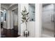 A bright bathroom features tiled walls, glass shower, tile floors, and a decorative potted tree at 31709 N 16Th Ave, Phoenix, AZ 85085