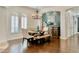 Dining room with a rustic wooden table, chandelier, and arched windows with white shutters at 31709 N 16Th Ave, Phoenix, AZ 85085