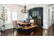 Charming dining room with a wooden table, bench seating, stylish chandelier, and elegant decor at 31709 N 16Th Ave, Phoenix, AZ 85085