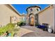 Charming courtyard entrance with stone tower, fountain, and lush greenery creates curb appeal at 31709 N 16Th Ave, Phoenix, AZ 85085