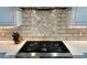 Close up of the gourmet kitchen with gas cooktop and decorative tile backsplash at 31709 N 16Th Ave, Phoenix, AZ 85085