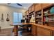 Spacious home office features custom wood built-in cabinetry and shelving at 31709 N 16Th Ave, Phoenix, AZ 85085