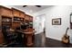 A home office features custom built-in shelving, a workspace, and natural lighting creating a workspace at 31709 N 16Th Ave, Phoenix, AZ 85085