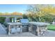 Outdoor kitchen featuring stone countertops, stainless steel grill, and stainless steel storage, surrounded by desert landscaping at 31709 N 16Th Ave, Phoenix, AZ 85085