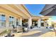 Covered patio with outdoor seating, potted plants, and a view of the landscaped backyard, offering a perfect spot to unwind at 31709 N 16Th Ave, Phoenix, AZ 85085