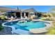 A sparkling swimming pool is surrounded by patio furniture, an outdoor grill, and green grass, perfect for relaxation and entertainment at 31709 N 16Th Ave, Phoenix, AZ 85085