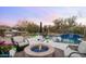 Relaxing pool area features a waterfall feature, fire pit, and grilling station for outdoor entertaining at 31709 N 16Th Ave, Phoenix, AZ 85085