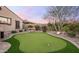 Backyard putting green offers a recreational amenity within a beautifully landscaped setting at 31709 N 16Th Ave, Phoenix, AZ 85085