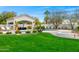 Serene backyard featuring a pool, covered lounge area, lush landscaping, and inviting seating at 3246 E San Miguel Pl, Paradise Valley, AZ 85253