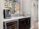 Stylish bar area with wine storage, a coffee machine, and sleek countertops at 3246 E San Miguel Pl, Paradise Valley, AZ 85253