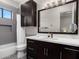 Well-lit bathroom featuring a sleek vanity, dark wood cabinets, and modern fixtures at 3246 E San Miguel Pl, Paradise Valley, AZ 85253