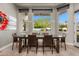 Bright dining room featuring large windows, wood floors, stylish furniture, and serene outdoor views at 3246 E San Miguel Pl, Paradise Valley, AZ 85253