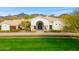 Stunning single-story home with a beautiful arched entryway, lush landscaping, and mountain views at 3246 E San Miguel Pl, Paradise Valley, AZ 85253