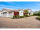 Elegant home with a paver driveway, red bougainvillea, and a three car garage at 3246 E San Miguel Pl, Paradise Valley, AZ 85253