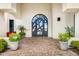 Elegant home entrance with a decorative iron door, brick walkway and well-manicured greenery at 3246 E San Miguel Pl, Paradise Valley, AZ 85253