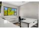 Bright home office featuring a modern white desk, ample storage, and a large window offering natural light at 3246 E San Miguel Pl, Paradise Valley, AZ 85253