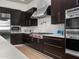 Well-equipped kitchen featuring professional-grade appliances, dark cabinetry, and a white subway tile backsplash at 3246 E San Miguel Pl, Paradise Valley, AZ 85253