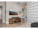 Cozy living room featuring Paris-themed wallpaper, a modern console, and an inviting atmosphere at 3246 E San Miguel Pl, Paradise Valley, AZ 85253