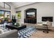 Beautiful living room featuring a fireplace, large television, and stylish decor at 3246 E San Miguel Pl, Paradise Valley, AZ 85253