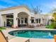 An inviting backyard pool area, featuring a covered patio and outdoor seating for luxurious relaxation at 3246 E San Miguel Pl, Paradise Valley, AZ 85253