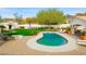 Lush backyard with a sparkling pool, fire pit, and lounge area at 3246 E San Miguel Pl, Paradise Valley, AZ 85253