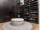 Spacious walk-in closet with custom dark wood shelving and drawers for organization and tufted ottoman at 3246 E San Miguel Pl, Paradise Valley, AZ 85253