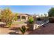 Backyard view showing landscaped area with brick accents and covered outdoor patio at 3254 N Park St, Buckeye, AZ 85396