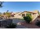 Backyard view showing landscaped area with brick accents and adjacent houses at 3254 N Park St, Buckeye, AZ 85396