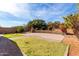 Landscaped backyard with block wall and terraced stone planter at 3254 N Park St, Buckeye, AZ 85396