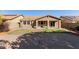 Backyard view showing landscaped area, grass, and covered outdoor patio at 3254 N Park St, Buckeye, AZ 85396