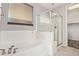 This bathroom features a large bathtub with a shower and a frosted window for natural light at 3254 N Park St, Buckeye, AZ 85396