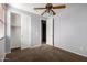 A neutral colored bedroom featuring a closet, and a ceiling fan at 3254 N Park St, Buckeye, AZ 85396