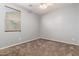 This bedroom features carpet, a ceiling fan, and a window offering natural light at 3254 N Park St, Buckeye, AZ 85396