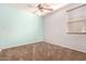 This bedroom features a ceiling fan, carpet, and a splash of color on the wall at 3254 N Park St, Buckeye, AZ 85396