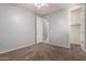 This bedroom features carpet, a ceiling fan, and a doorway into a walk-in closet at 3254 N Park St, Buckeye, AZ 85396