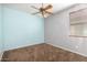 This bedroom boasts a ceiling fan and neutral carpet at 3254 N Park St, Buckeye, AZ 85396