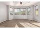 Bedroom with neutral carpet, ceiling fan, and lots of natural light from bay windows at 3254 N Park St, Buckeye, AZ 85396