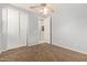 This bedroom features a ceiling fan, carpet, closet, and a doorway into another part of the home at 3254 N Park St, Buckeye, AZ 85396