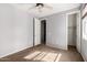 Neutral bedroom, with a fan, window, and closet space at 3254 N Park St, Buckeye, AZ 85396