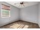 This bedroom features neutral carpeting, a ceiling fan, and neutral walls at 3254 N Park St, Buckeye, AZ 85396