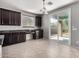 Eat-in kitchen featuring dark cabinets, granite countertops, and a sliding glass door to the patio at 3254 N Park St, Buckeye, AZ 85396