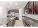 Well-equipped kitchen featuring stainless appliances, granite counters, island with sink, and gas cooktop at 3254 N Park St, Buckeye, AZ 85396