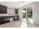 Kitchenette with granite countertop, dark cabinets and stainless under-mount sink with view to backyard patio at 3254 N Park St, Buckeye, AZ 85396